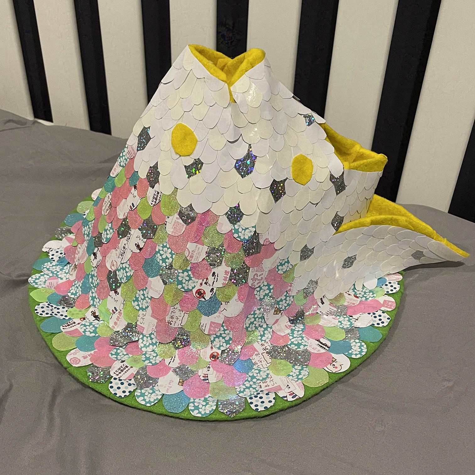 Hat right side. Scales predominantly pink color.