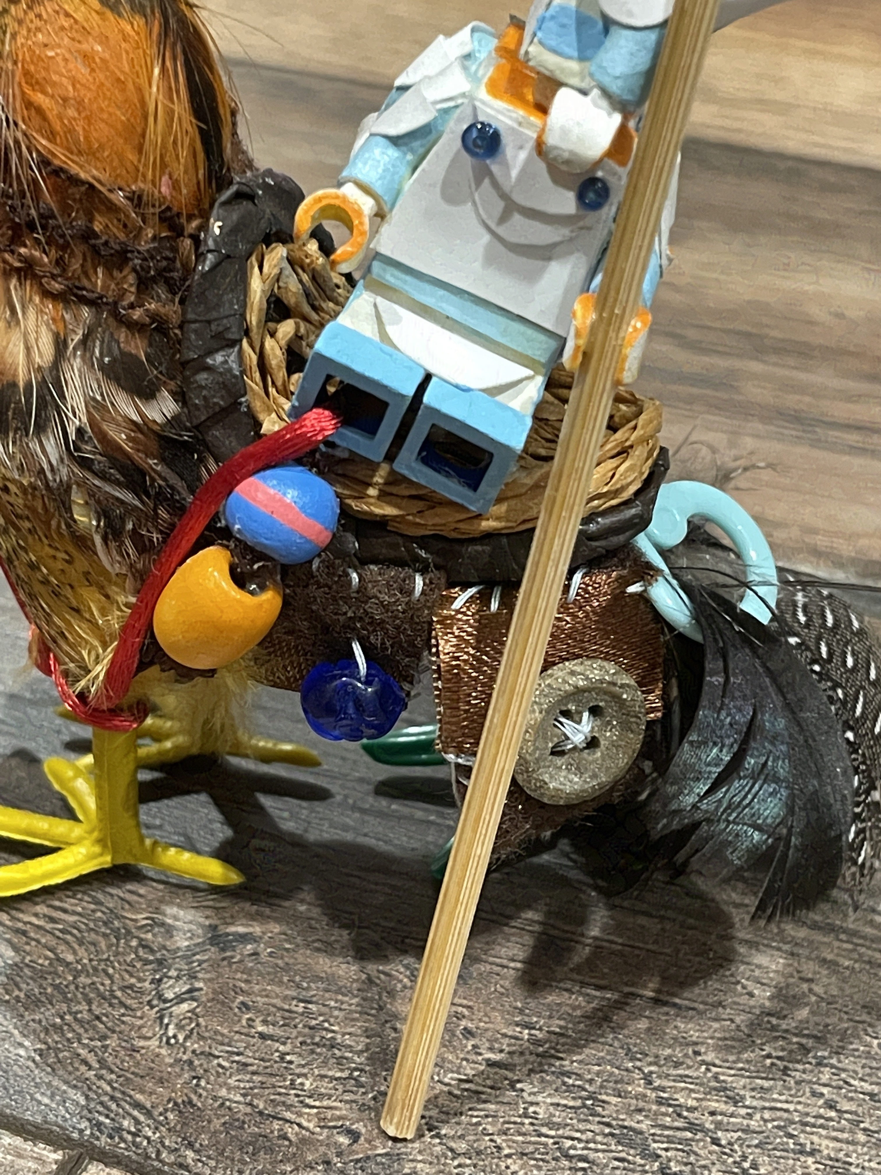 Chicken saddle has beads and a satchel attached to the side.